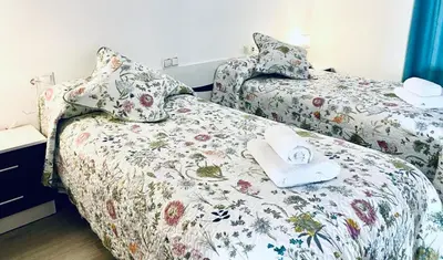 a bedroom with two beds with towels on them at Alojamiento en Losa del Obispo in Losa del Obispo