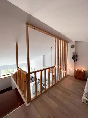 a room with a staircase with a view of the ocean at Alojamiento en Losa del Obispo in Losa del Obispo