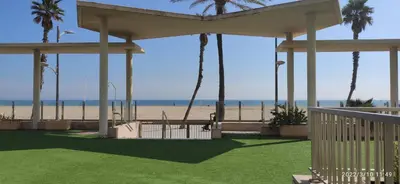 a gazebo on the beach with palm trees at Sunny&Beach in Valencia in Valencia