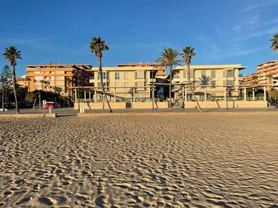 an empty beach with palm trees and a playground at Sunny&Beach in Valencia in Valencia