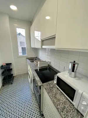 a small room with a bed and a tiled floor at Ruzafa Vibes Apartments in Valencia