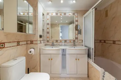 a bathroom with two sinks and a shower and a toilet at Platja Puig in Valencia