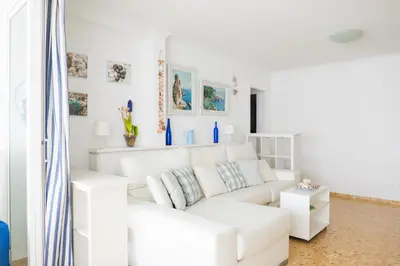 a white living room with a white couch at Platja Puig in Valencia