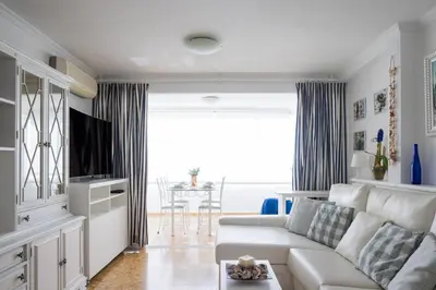 a living room with a white couch and a table at Platja Puig in Valencia