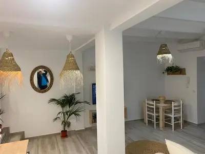 a living room with a table and chandeliers at Alzira bonita Apartamento B con patio, la Casella in Alzira
