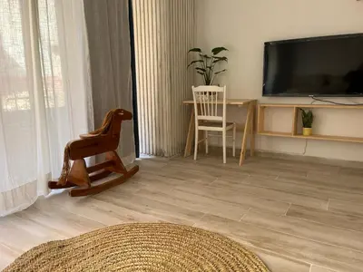 a living room with a television and a table and chair at Alzira bonita Loft C junto plaza mayor, Les Muralles in Alzira