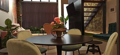 a table with a vase of flowers on top of it at Encantador Loft a un Paso del Río Turia in Valencia