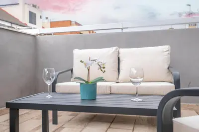 a coffee table with a couch and two wine glasses at Spacious Penthouse with Private Terrace in Valencia