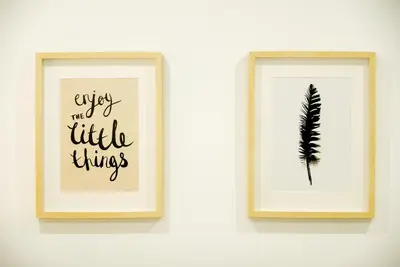 two framed prints of a feather on a wall at Apt with Fluffy Beds & Private Patio in Valencia