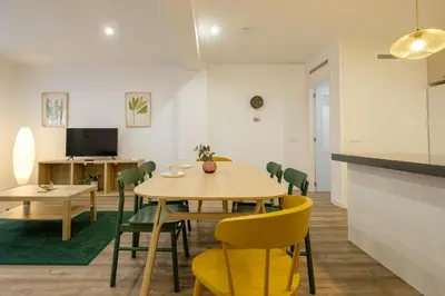 a dining room with a table and chairs at Apt with Fluffy Beds & Private Patio in Valencia