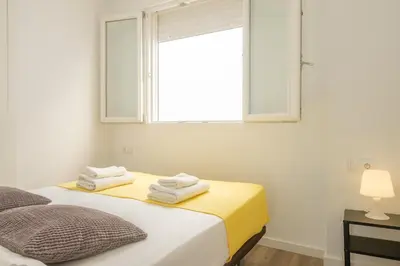a bedroom with a bed with towels on it at Modern Penthouse with Private Terrace in Valencia