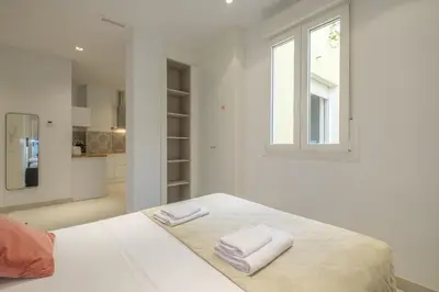 a white bedroom with two towels on a bed at Chic & Comfortable Apartment, Private Terrace in Valencia