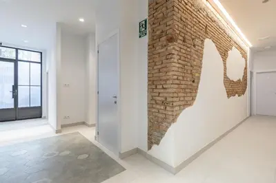 an empty room with a brick wall and a door at Chic & Comfortable Apartment, Private Terrace in Valencia