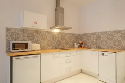 a kitchen with white cabinets and a microwave at Gorgeous Apartment close to City Centre in Valencia