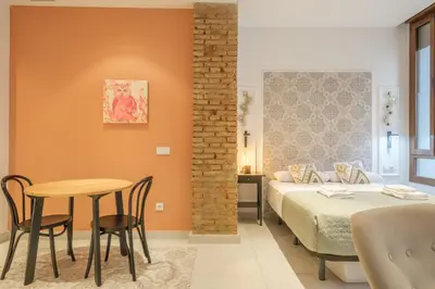a bedroom with a bed and a table and chairs at Gorgeous Apartment close to City Centre in Valencia
