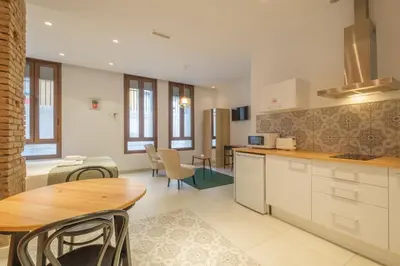 a kitchen with a table and a dining room at Gorgeous Apartment close to City Centre in Valencia