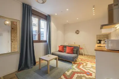 a living room with a couch and a table at Apt with Antique Floor & lots of Sun Light in Valencia
