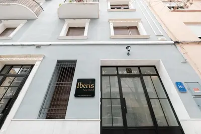 a white building with a sign on it at Apt with Antique Floor & lots of Sun Light in Valencia
