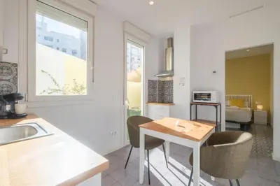 a kitchen with a table and chairs in a room at Marvellous Apt with a Large Private Terrace in Valencia