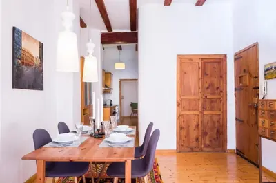 a dining room with a wooden table and chairs at Old Town Plaza Negrito by Nomad Host in Valencia