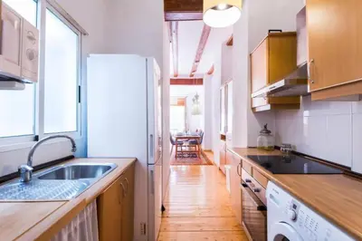 a kitchen with a sink and a refrigerator at Old Town Plaza Negrito by Nomad Host in Valencia
