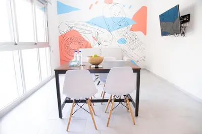 a dining room with a table and two white chairs at VLC HOST - Cuber in Valencia