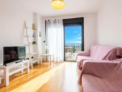 a living room with a couch and a television at Apartment Porte Venere by Interhome in Moncófar