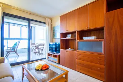 a living room with a large entertainment center and a television at ESPACIO 16 - Primera LINEA PLAYA in Cullera