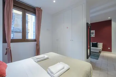 a bedroom with a bed and a window and a couch at Modern Apartment close to City Centre in Valencia