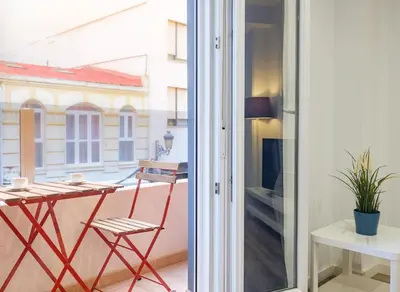 a room with a balcony with a table and a chair at Apartment With Super Comfortable Beds in Valencia