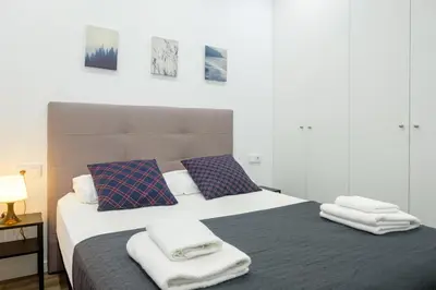 a bedroom with a bed with towels on it at Apartment With Super Comfortable Beds in Valencia