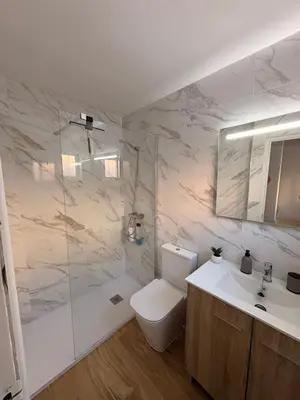 a bathroom with a toilet and a sink and a tub at Apartamento Casa Quiles in Losa del Obispo