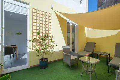 a room with a tree and chairs and a table at Gorgeous Apt with a Large Private Terrace in Valencia