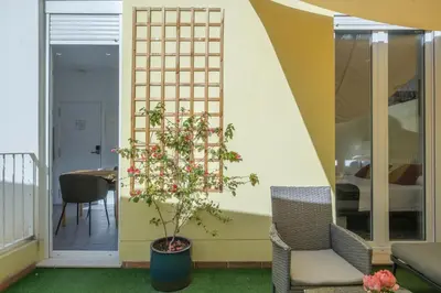 a small tree in a pot next to a chair at Gorgeous Apt with a Large Private Terrace in Valencia