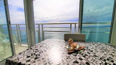 a table in a room with a view of the ocean at Fantastico apartamento Faro de cullera a primera linea mar abierto playa de los olivos in Faro de Cullera