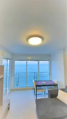a living room with a table and views of the ocean at Fantastico apartamento Faro de cullera a primera linea mar abierto playa de los olivos in Faro de Cullera