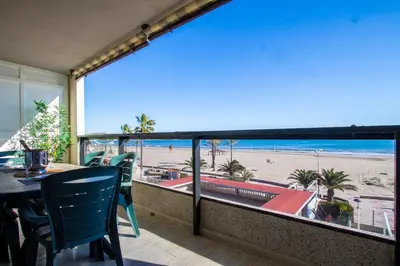 a balcony with a table and chairs and a view of the beach at ESPACIO 2 Primera LINEA DE PLAYA in Cullera