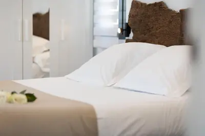 a bedroom with a white bed with white pillows at Casa Rural Espadan Suites in Artana