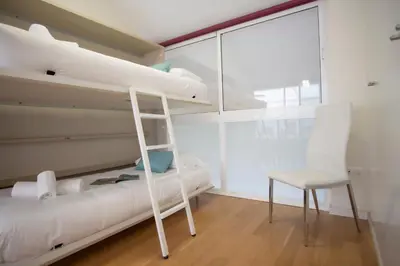 a bunk bed and a chair in a room at SingularStays Comedias IV in Valencia