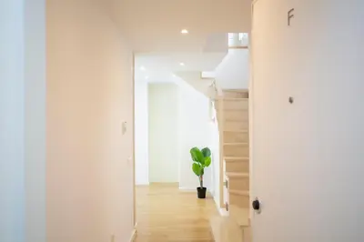 a hallway with a staircase and a potted plant at SingularStays Comedias IV in Valencia