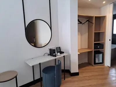 a room with a mirror and a table and chairs at Soho Boutique Turia in Valencia