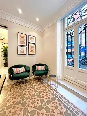 a living room with two chairs and a window at Soho Boutique Turia in Valencia