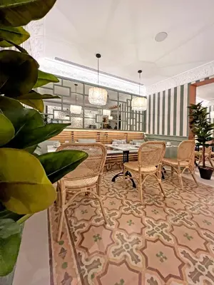 a lobby with chairs and a table in a building at Soho Boutique Turia in Valencia