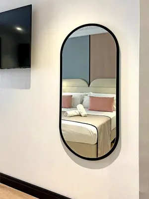 a mirror on a wall with a bed in a room at Soho Boutique Turia in Valencia