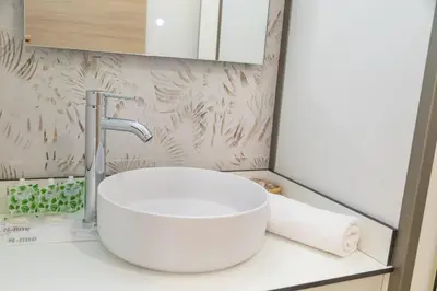 a bathroom with a white sink and a mirror at Travel Habitat La Marina Real in Valencia
