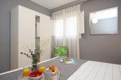 a table with a bowl of fruit and a plate of orange juice at SingularStays Baleares in Valencia
