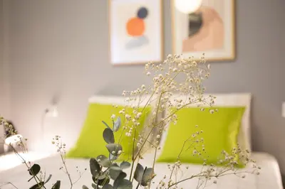 a living room with a couch with green pillows at SingularStays Baleares in Valencia