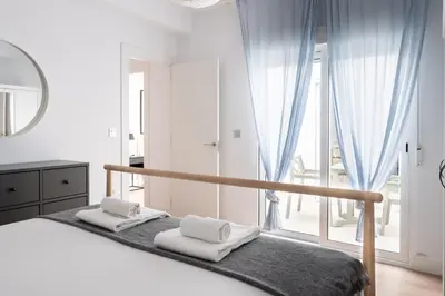 a bedroom with a bed and a large window at Casa señorial en el corazón del Puerto by Hometels in Puerto de Sagunto