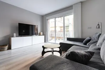 a living room with a couch and a tv at Casa señorial en el corazón del Puerto by Hometels in Puerto de Sagunto