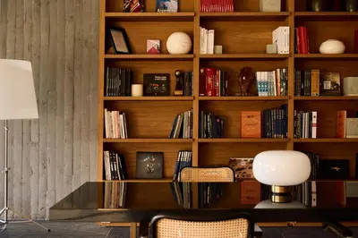 a room with a book shelf filled with books at La Galiana Golf Resort - Adults Only in Barraca de Aguas Vivas